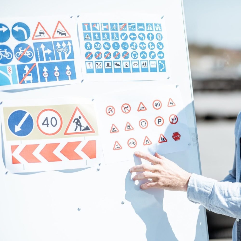 driver-instructor-showing-traffiic-signs.jpg